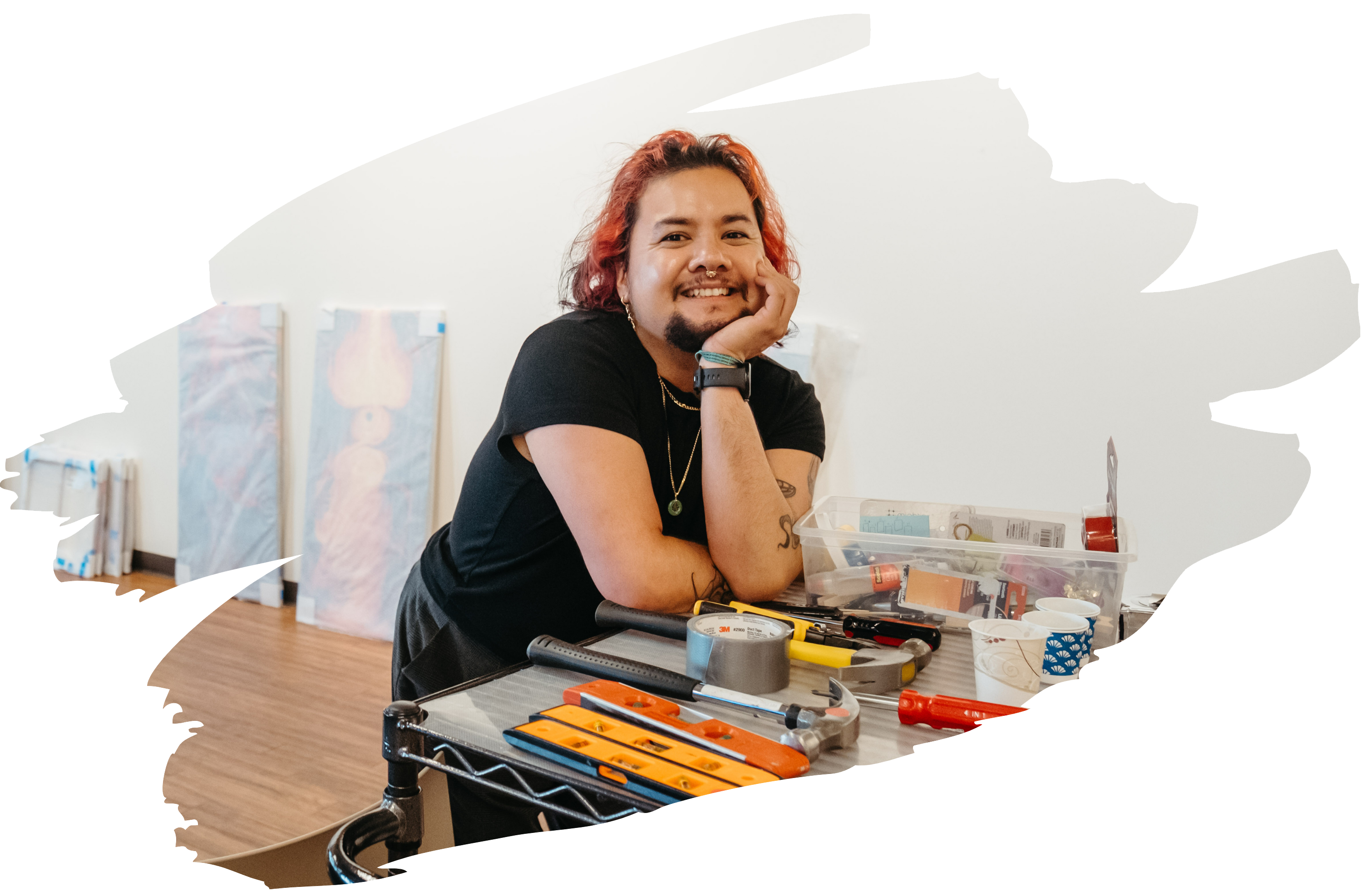 Tanza smiling as he rests on a toolcart